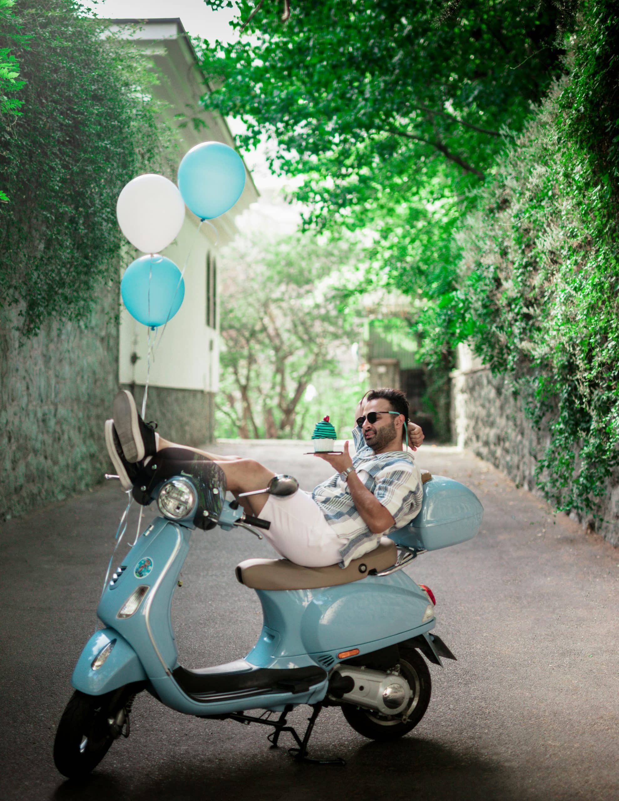 birthday guy with balloons on a moped scooter